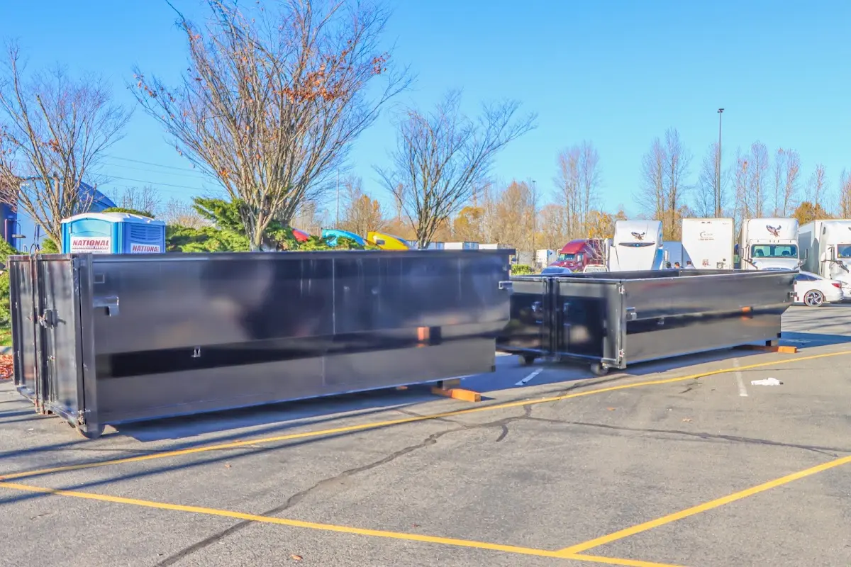 Professional dumpster rental service with roll-off container on residential driveway in La Homa